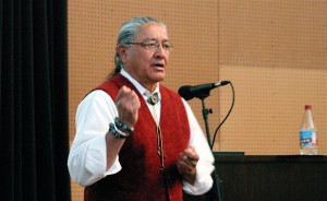 Mike Wilson, a member of the Tohono O’odham nation and a human rights activist, talks about his weapon of choice, water, far right. He places caches of water at aid stations throughout the reservation. He made his presentation April 10 in front of about 100 audience members at the Native American Cultural Center at Northern Arizona University. Photos by Frank X. Moraga / AmigosNAZ