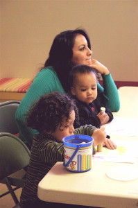 A caregiver / instructor helps provide early childhood education lessions to young people during Arizona Kith and Kin Project class held in early November at Our Lady of Guadalupe Catholic Church in Flagstaff. The 14-week program, which provides early childhood education information to caregivers, is one of a number of local programs availble for youth in the region. Photo by Frank X. Moraga / AmigosNAZ ©2014