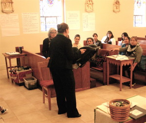 Amanda Green, left, leads a class in Spanish on proper child safety seat installation during a November meeting of the Arizona Kith and Kin Project at Our Lady of Guadalupe Catholic Church in Flagstaff.