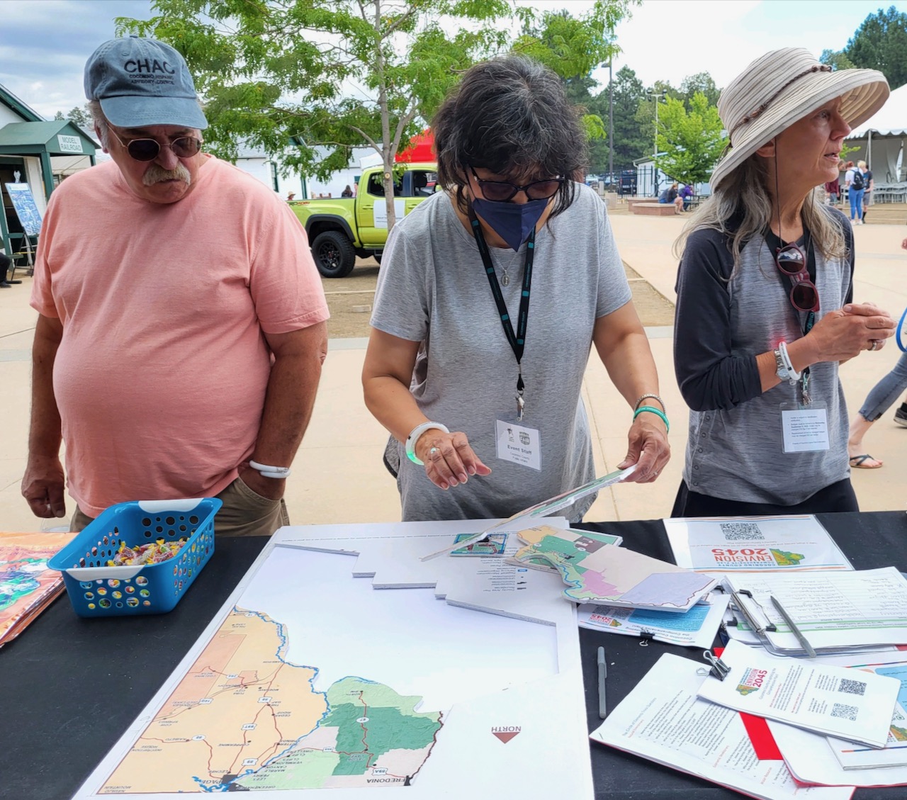 CHAC President Patrcia Garcia, center, looks over Coconino County vision maps.