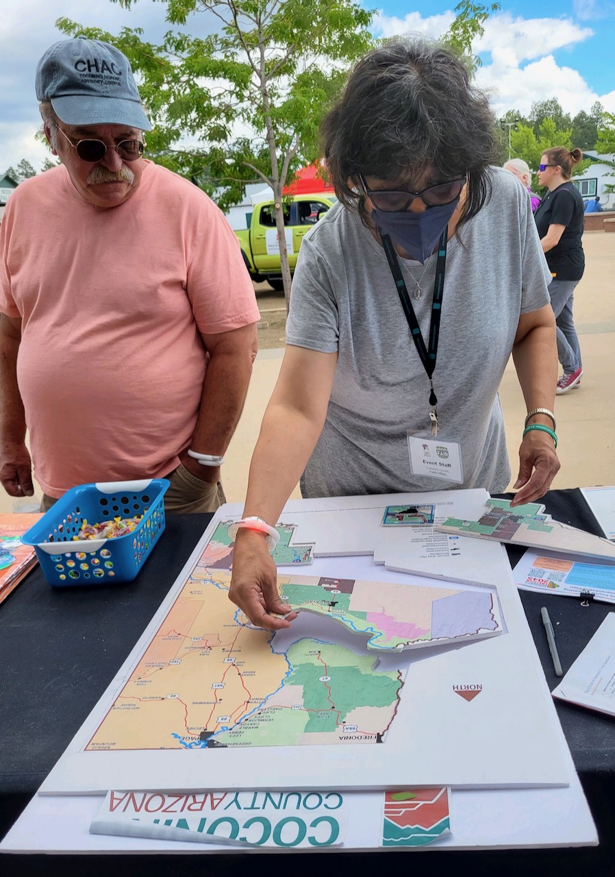 CHAC President Patrcia Garcia, center, looks over Coconino County vision maps.